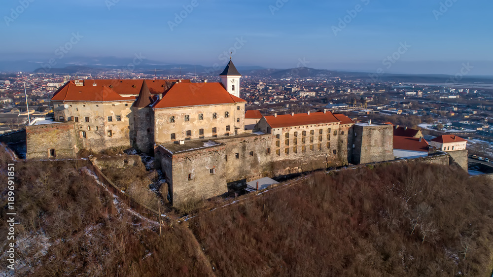 Beautiful panoramic aerial view to Palanok Castle at sunset and the city of Mukachevo