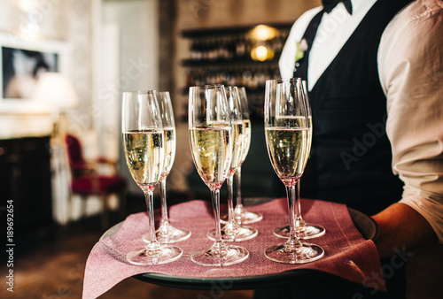 waiter brings glasses of champagne © VAKSMANV