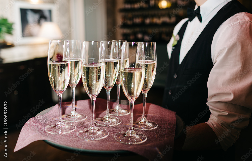 waiter brings glasses of champagne waiter brings glasses of champagne
