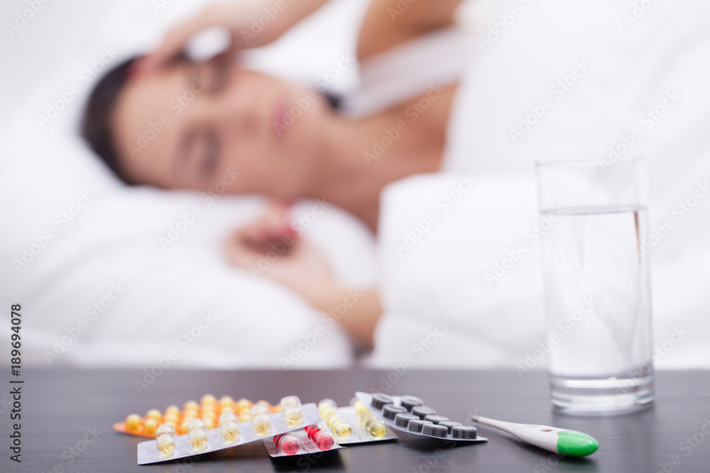 Asleep unhealthy woman and pills on the nightstand Asleep unhealthy woman and pills on the nightstand
