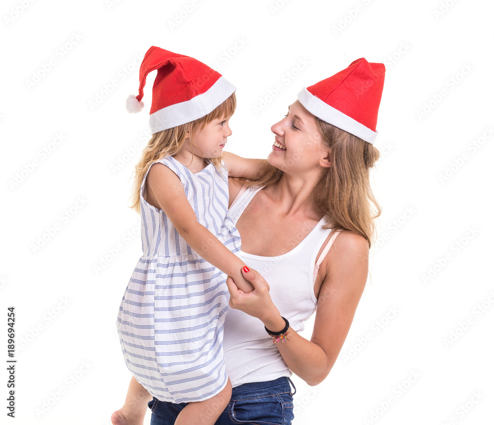 Christmas and New Year concept : Portrait happy mother and daughter were red Christmas hat isolated on white Christmas and New Year concept : Portrait happy mother and daughter were red Christmas hat isolated on white