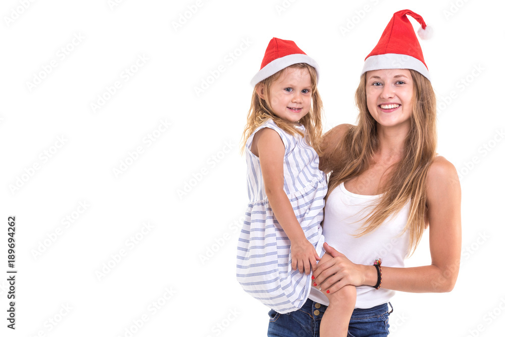 Christmas and New Year concept : Portrait happy mother and daughter were red Christmas hat isolated on white Christmas and New Year concept : Portrait happy mother and daughter were red Christmas hat isolated on white