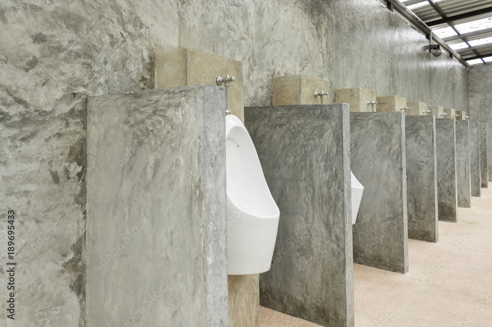 White Urinal Men in Men Public Toilet with Concrete Wall Loft Style Wide Angle White Urinal Men in Men Public Toilet with Concrete Wall Loft Style Wide Angle