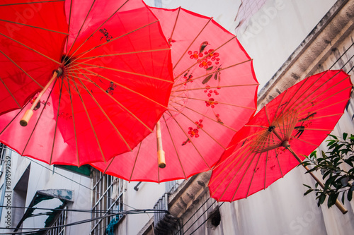 Decorative red umbrellas in asian street