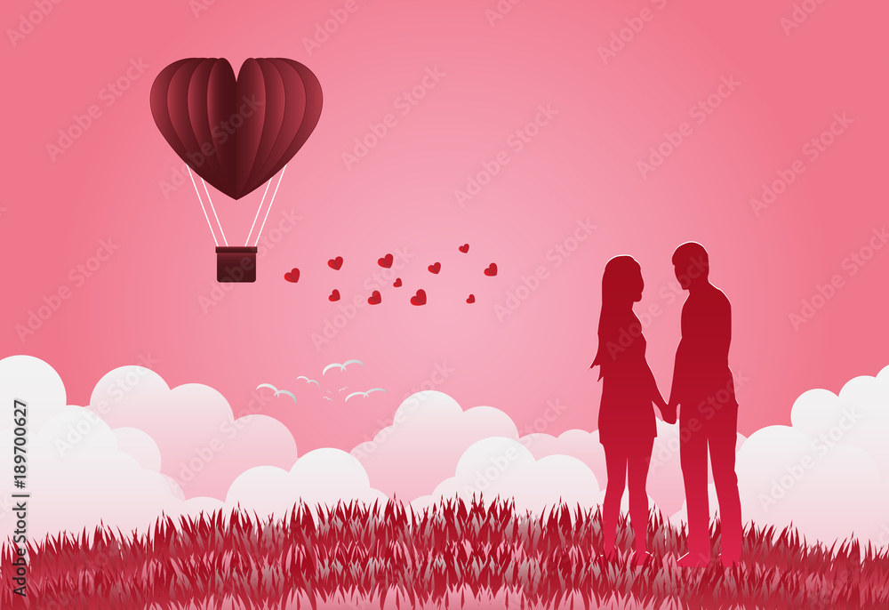Fototapeta Valentine's day balloons in a heart shaped flying over grass view background,Standing hand in hand, showing love to each other. paper art style.