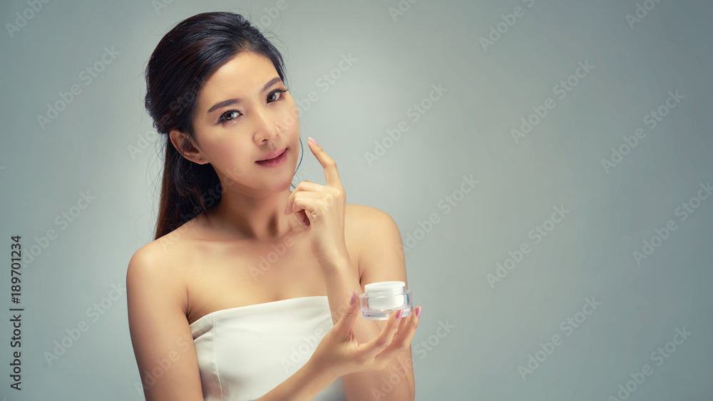 Happy beautiful asian girl with the fresh skin in grey colour background. Expressive facial expressions. Cosmetology and Spa concept. Happy beautiful asian girl with the fresh skin in grey colour background. Expressive facial expressions. Cosmetology and Spa concept.