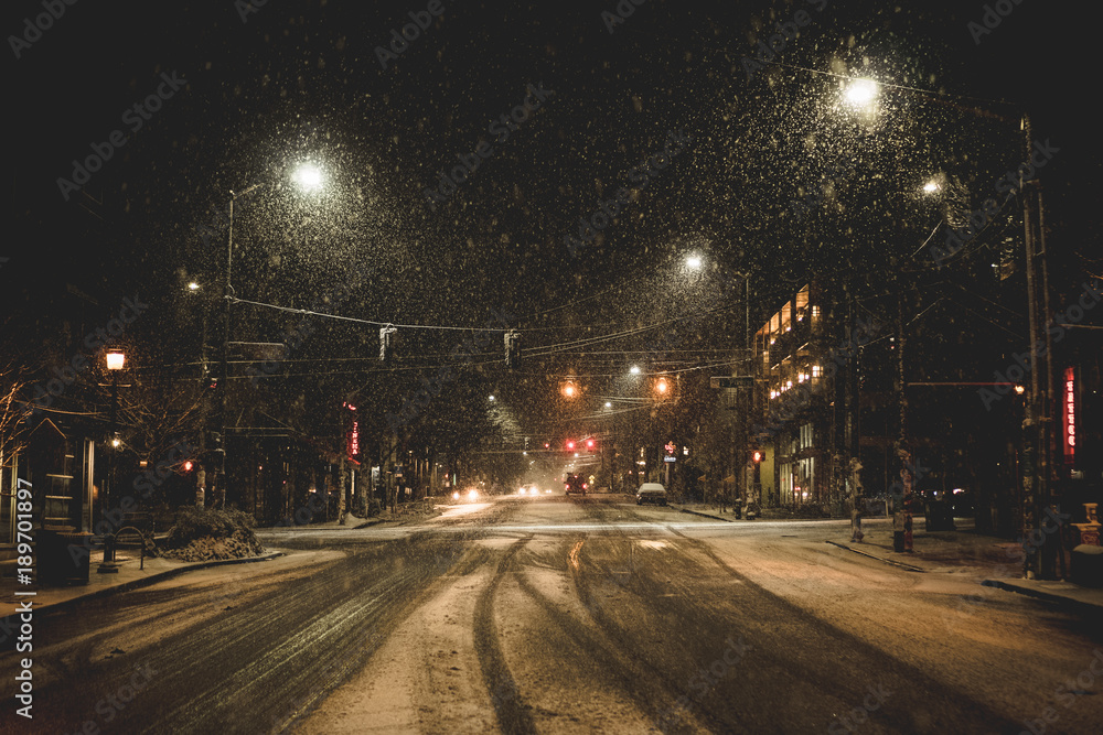 a crosswalk in snow at night