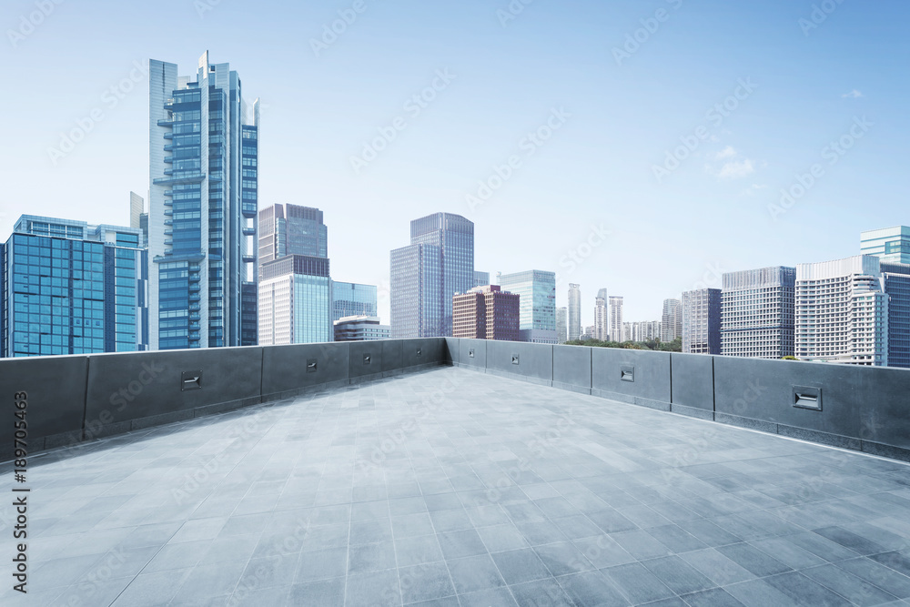 © jamesteohart - Empty open space top floor  with modern skyscraper building .