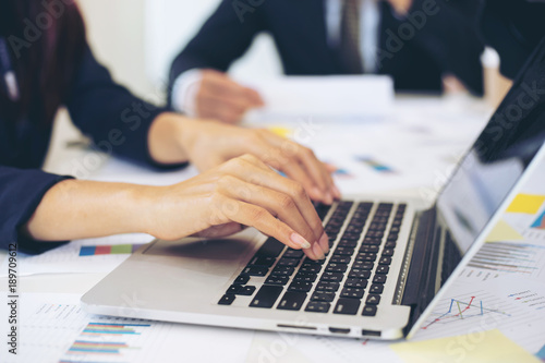 close up hand of business woman employees secretary using laptop minutes of executive meeting - business concept