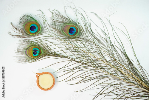 Top or flat lay view of a peacock feathers on a white background with a words HAPPY THAIPUSAM DAY. Celebrate by a hindu religions.  A religions conceptual. photo