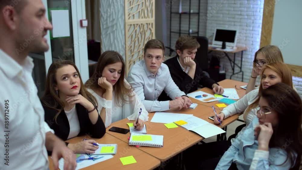 Group of students taking notes in the university lecture. Concentrated people studying intensively in the classroom. 4 k Group of students taking notes in the university lecture. Concentrated people studying intensively in the classroom. 4 k