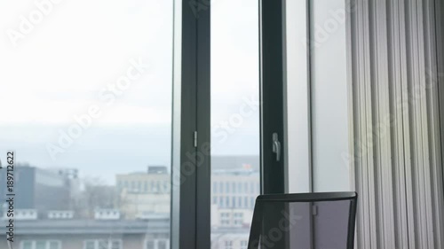 A young businesswoman entering the room and starting work. Medium. Dolly shot.