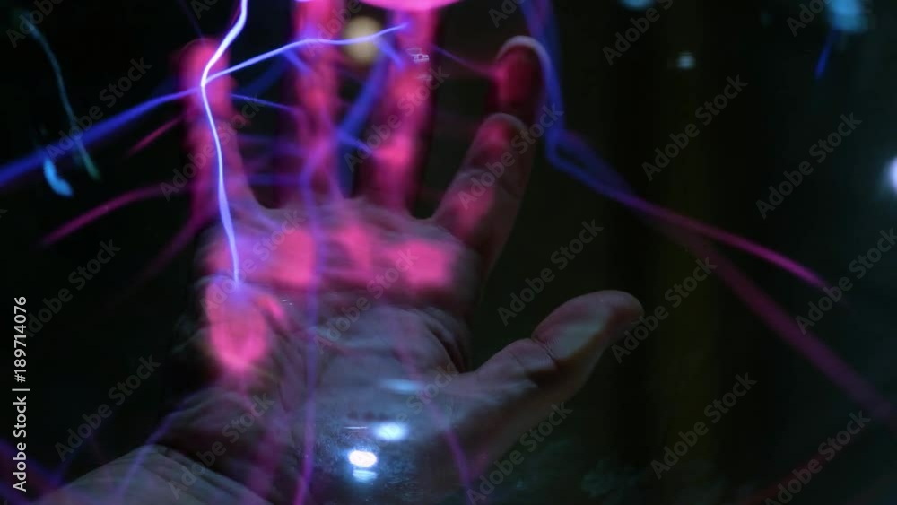Abstract lightning in a plasma balloon. Scanning the hand and fingerprint. The system of fingerprint security. Transmission of electricity by air, wireless transmission of electricity Abstract lightning in a plasma balloon. Scanning the hand and fingerprint. The system of fingerprint security. Transmission of electricity by air, wireless transmission of electricity