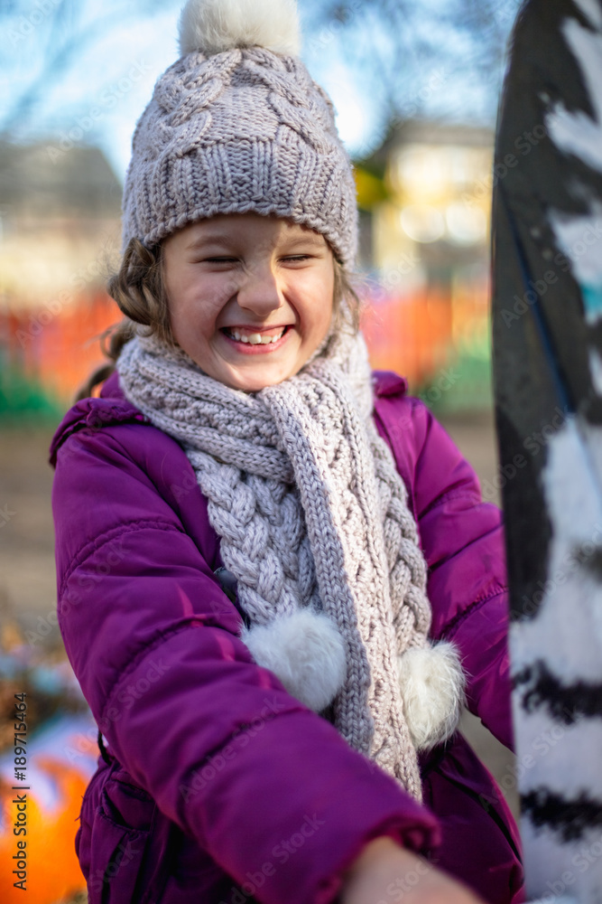 A cute little girl on a playground in autumn. A cute little girl on a playground in autumn.