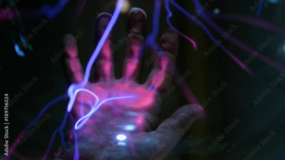 Abstract lightning in a plasma balloon. Scanning the hand and fingerprint. The system of fingerprint security. Transmission of electricity by air, wireless transmission of electricity Abstract lightning in a plasma balloon. Scanning the hand and fingerprint. The system of fingerprint security. Transmission of electricity by air, wireless transmission of electricity