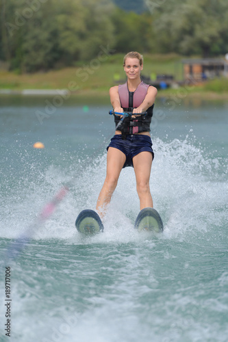 happy young girl on a water ski photo
