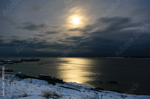 Moon at night in winter. White Sea in Rabocheostrovsk, Kem, Russia