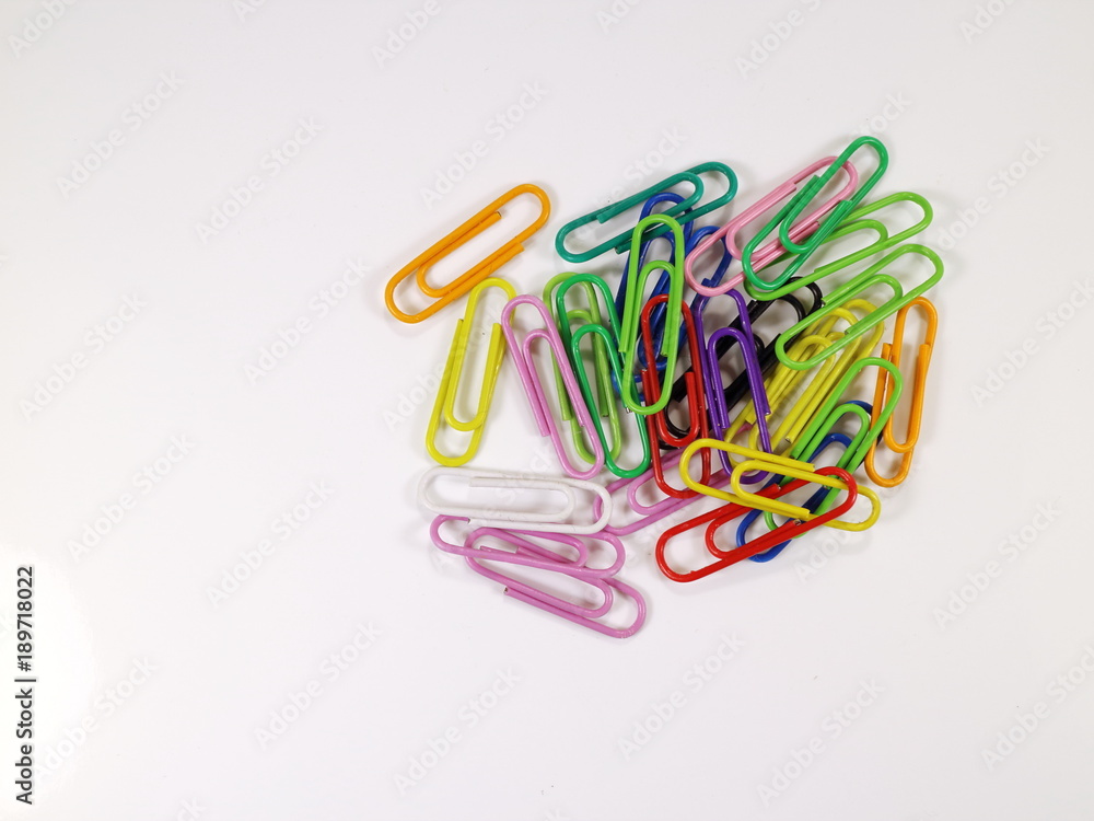 paper clips of different colors on a white background paper clips of different colors on a white background