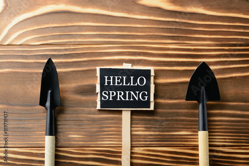 Hello Spring sign with tools on table photo