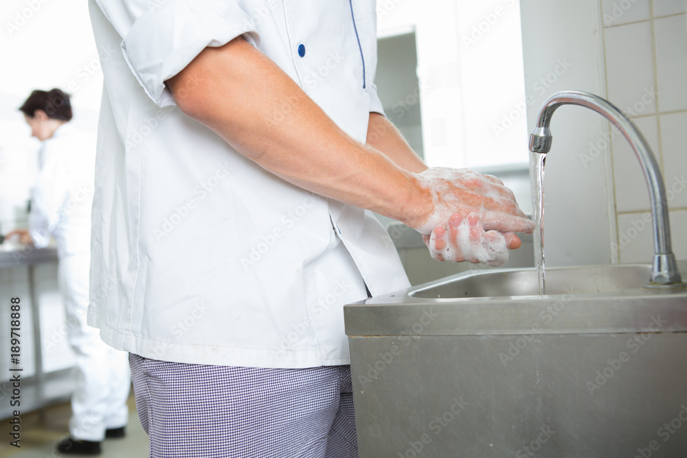 Fototapeta premium chefs washing hands in an industrial kitchen