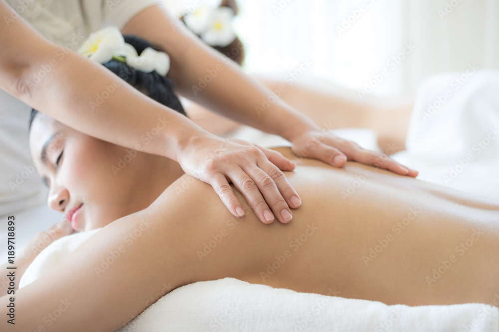 beautiful and healthy young woman relaxing with back massage in spa salon beautiful and healthy young woman relaxing with back massage in spa salon