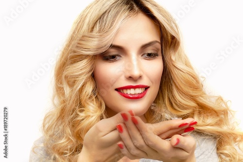 Transparent contact lens in the hands of a beautiful blonde who is preparing to insert it. Top view.