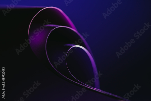 arcs of purple paper on dark blue