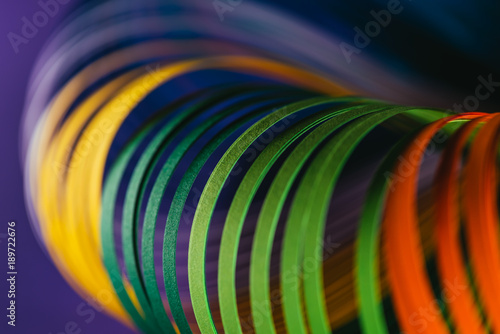 close up of colored quilling paper curves on purple