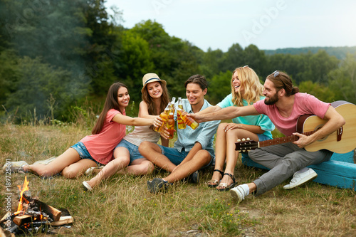 Happy Friends Having Fun On Picnic In Nature