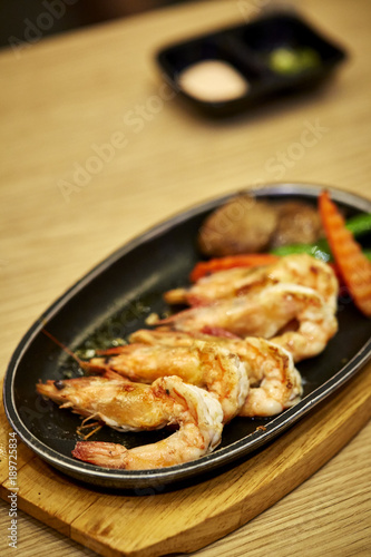 Japanese seafood. Fried spicy shrimps with herbs