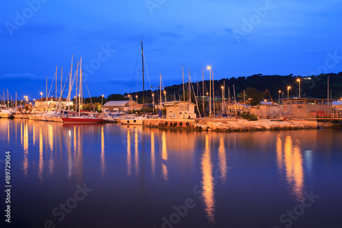 Yachts moored in the harbor channel in Pesaro  Marche  Italy. Night view.