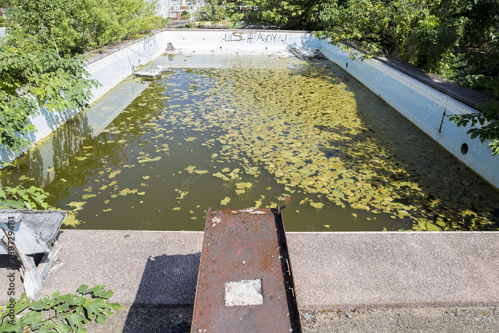 Abandoned public swimming pool in Thailand, construction concept, dirty