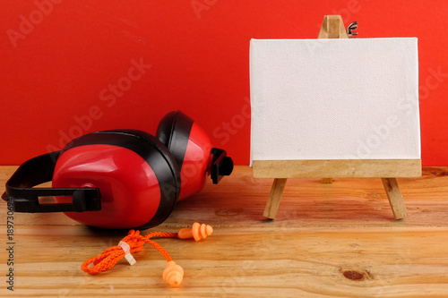 HEALTH AND SAFETY CONCEPT. Personal protective equipment on wooden table over red background. photo