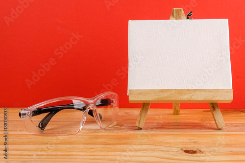 HEALTH AND SAFETY CONCEPT. Personal protective equipment on wooden table over red background. photo