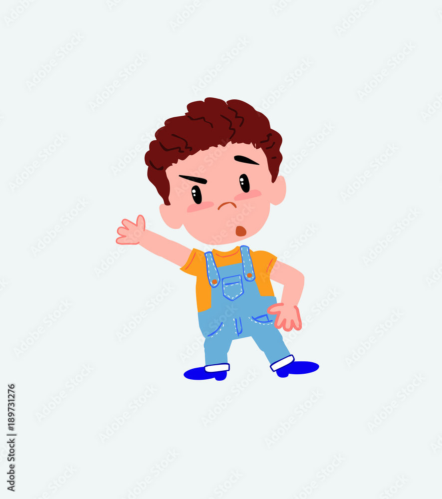White boy in jeans something angry shows something to his right. White boy in jeans something angry shows something to his right.