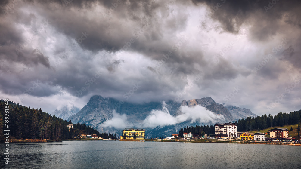 Misurina Lake in the Dolomites mountains in Italy near Auronzo di Cadore on a cloudy day, Sorapiss mountain in the background. South Tyrol, Dolomites, Italy.