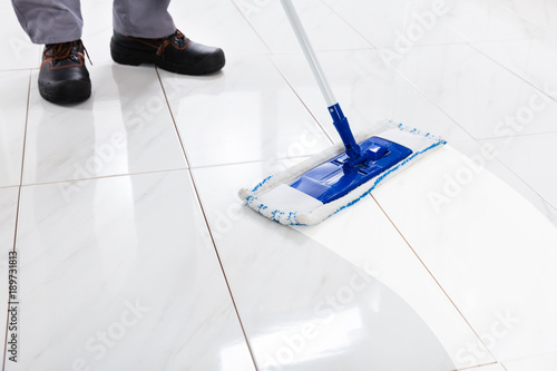 Worker Mopping Floor