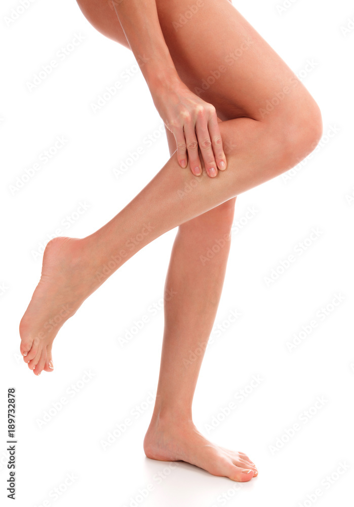 Closeup shot of woman holding sore leg, isolated on white background Closeup shot of woman holding sore leg, isolated on white background