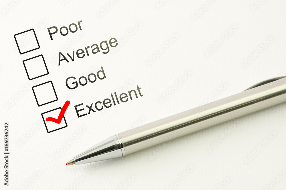 Excellent customer service feed back. Consumer satisfaction concept. Marked checkbox with a pen on paper background Excellent customer service feed back. Consumer satisfaction concept. Marked checkbox with a pen on paper background