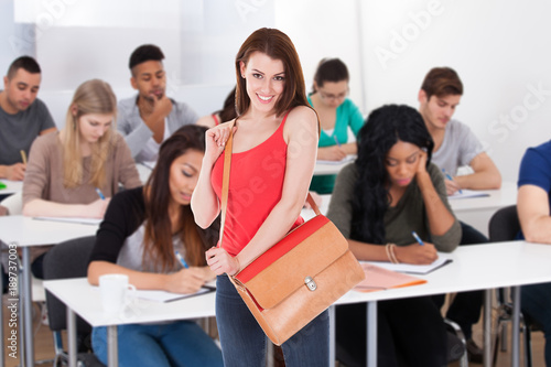 Confident Student Standing Against White Background