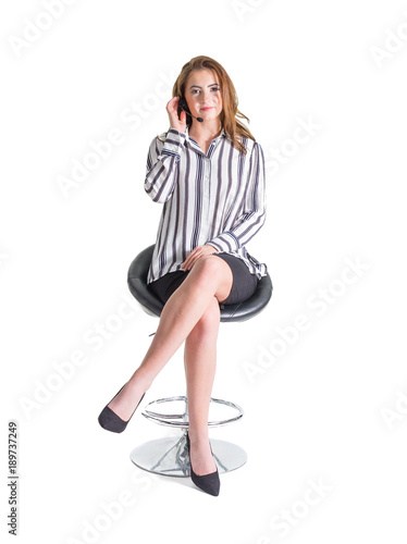 Woman Using Headset Telephone on a White Background. Isolated full length, looking at the camera. For sales, reception, training, contact or call centre. .