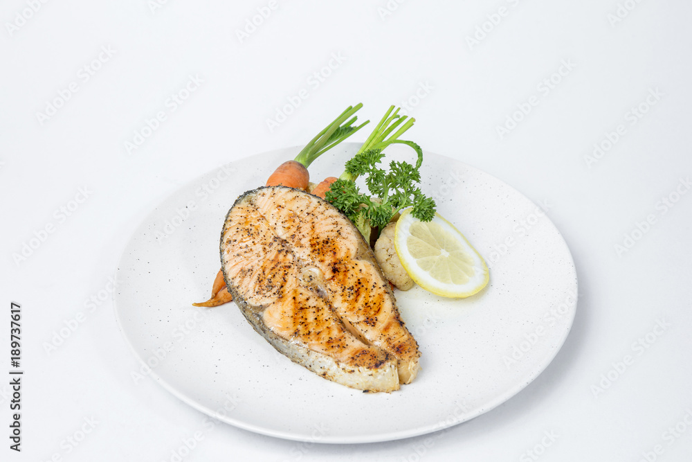 Salmon steak served with cooked vegetables Salmon steak served with cooked vegetables