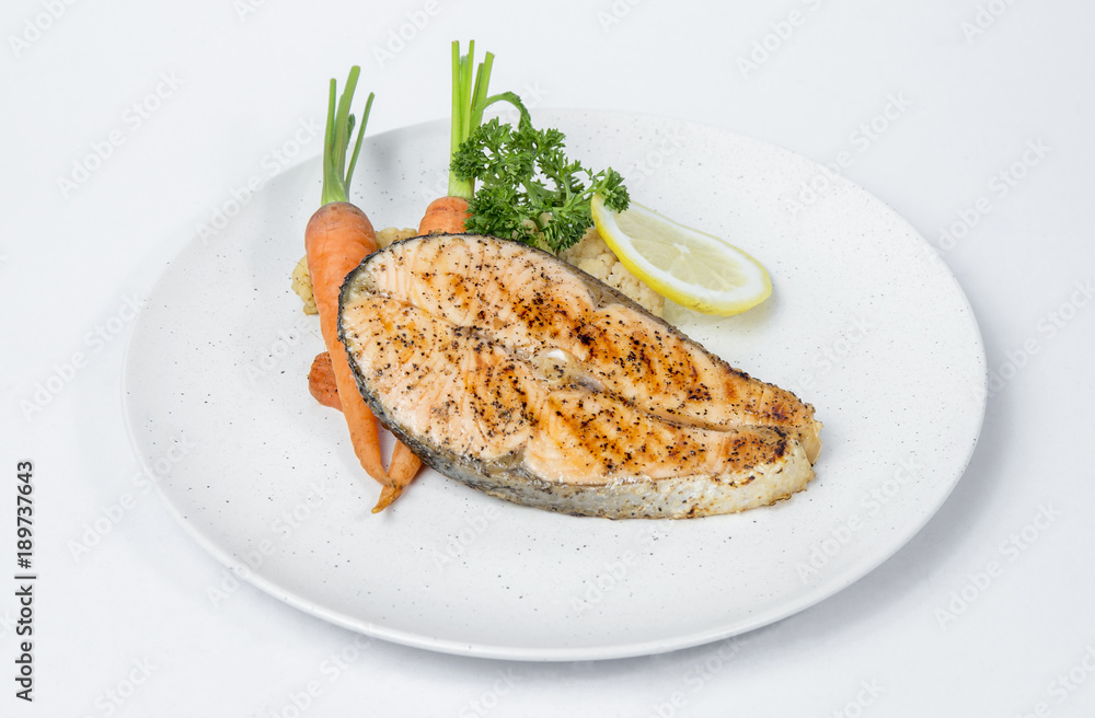 Salmon steak served with cooked vegetables Salmon steak served with cooked vegetables