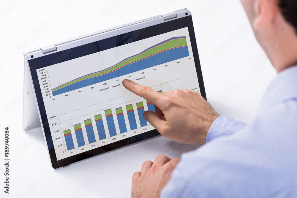 Businessman Analyzing The Chart On The Digital Tablet Businessman Analyzing The Chart On The Digital Tablet