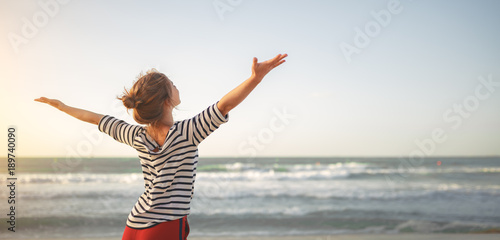happy woman enjoying freedom with open hands on sea photo