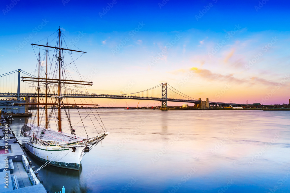 Cityscape of Philadelphia, Delaware River and Benjamin Franklin Bridge. Taken near Blue Cross RiverRink Park. Located in Philadelphia, Pennsylvania, USA. Cityscape of Philadelphia, Delaware River and Benjamin Franklin Bridge. Taken near Blue Cross RiverRink Park. Located in Philadelphia, Pennsylvania, USA.