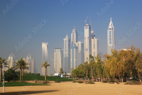 GOLF COURSE WITH DUBAI MARINA SKYSCRAPER AS BACK GROUND, DUBAI UAE © mastersbaby0526