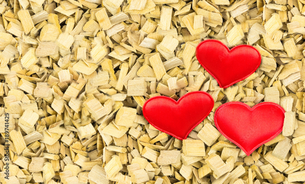 Couple of hearts made of cloth red symbol of love, a symbol of the holiday Valentine day design on wooden chips, eco background Couple of hearts made of cloth red symbol of love, a symbol of the holiday Valentine day design on wooden chips, eco background