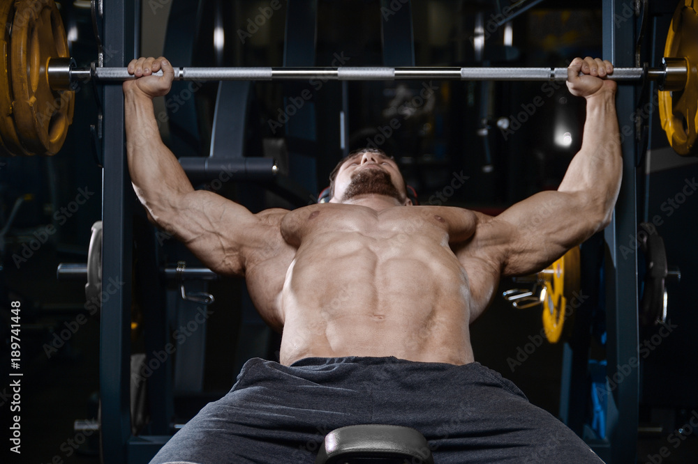 Brutal strong bodybuilder athletic men pumping up muscles with dumbbells. Brutal strong bodybuilder athletic men pumping up muscles with dumbbells.
