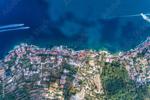 Aerial view of motor boats that run along the water surface leaving a white trail. Montenegro.